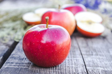 Fresh ripe red apples lie on a wooden table. Vitamins and a healthy diet. Vegetarian concept.