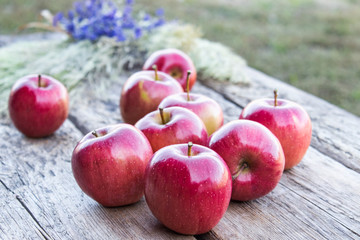 A lot of apples on a wooden table. Vitamins and a healthy diet. Vegetarian concept.