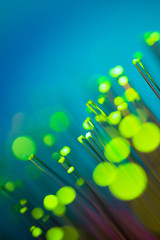 Optical fiber of various colors, foreground with bokeh