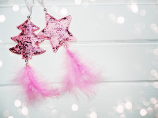 christmas decorations with feathers on white wooden background