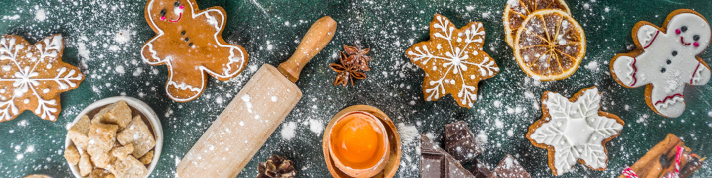 Christmas, New Year cooking background. Baking ingredients and utensils - flour, rolling pin, gingerbread, milk, eggs. Making festive Christmas sweet cookies. Top view copy space