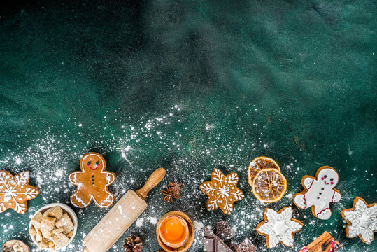 Christmas, New Year cooking background. Baking ingredients and utensils - flour, rolling pin, gingerbread, milk, eggs. Making festive Christmas sweet cookies. Top view copy space