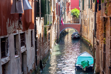 Narrow canal in old town of Venice - Italy