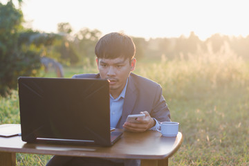 man working on his laptop in the park