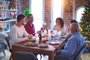 Beautiful family smiling happy and confident. Eating roasted turkey celebrating Christmas at home