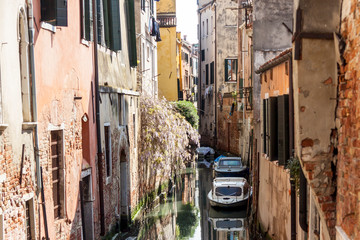 Narrow canal in old town of Venice - Italy