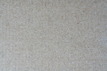 Light brown background from sheet of recycled cardboard. Closeup detail view of abstract texture recycled eco-friendly material pattern background.