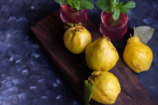 The fruits of quince. They differ in their useful properties. Suitable for food in baked, boiled form. Have a yellow color. Fruit campot in the background. Horizontal layout. Copy space. 