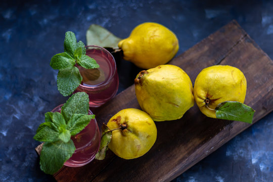 The fruits of quince. They differ in their useful properties. Suitable for food in baked, boiled form. Have a yellow color. Fruit campot in the background. Horizontal layout. Copy space. 