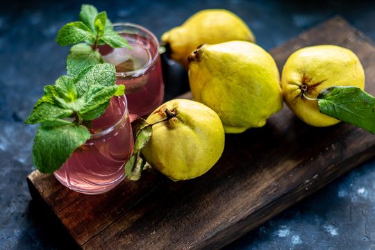 The fruits of quince. They differ in their useful properties. Suitable for food in baked, boiled form. Have a yellow color. Fruit campot in the background. Horizontal layout. Copy space. 