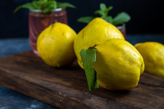 The fruits of quince. They differ in their useful properties. Suitable for food in baked, boiled form. Have a yellow color. Fruit campot in the background. Horizontal layout. Copy space. 