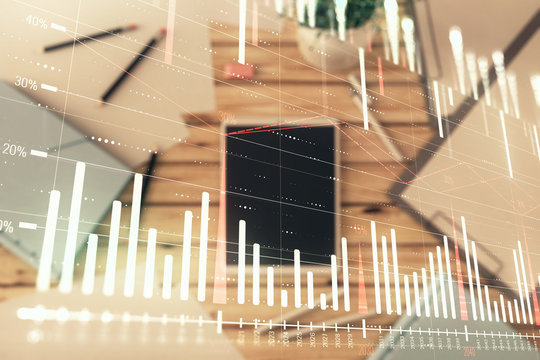 Double exposure of forex graph on digital tablet laying on table background. Concept of market analysis © Andrey