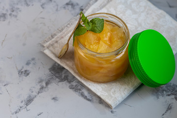 The fruits of quince. They differ in their useful properties. Suitable for food in baked, boiled form. Have a yellow color. Near jam of these fruits. Horizontal location. Copy space. 