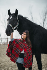 Obraz premium Girl with a horse at the stables