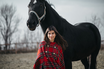 Obraz premium Girl with a horse at the stables