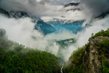 View of Norwegian lake between fjords with cloudy blue sky Eagle Road near Gairanger