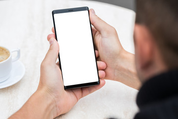 Close up of man's hands holding mobile smart phone.
