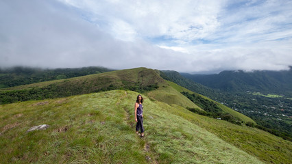 Fototapeta na wymiar Female hiker walking on top of India Dormida mountain at El Valle de Aton, Panama