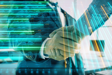 Multi exposure of financial graph on office background with two businessmen handshake. Concept of success in business