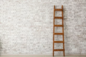 Deurstickers Wooden ladder near brick wall © Pixel-Shot