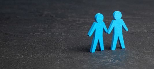 Two GAY men holding hands. Black background