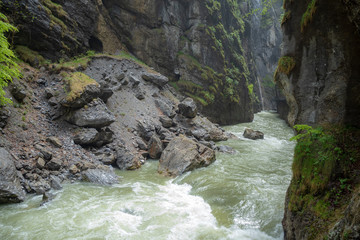 Beautiful view of small flowing stream with rock valley in the Aare Gorge (Aareschlucht) in the vally of Hasli, Meiringen, Switzerland