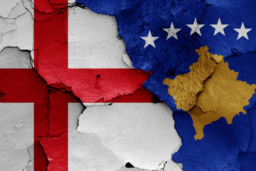 flags of England and Kosovo painted on cracked wall