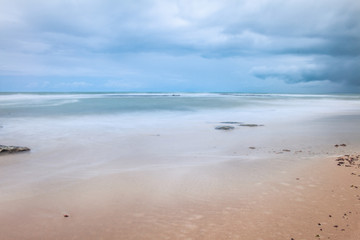 Fototapeta na wymiar Several rocks on the beach. Coastal landscape. Lonely landscape by the sea.