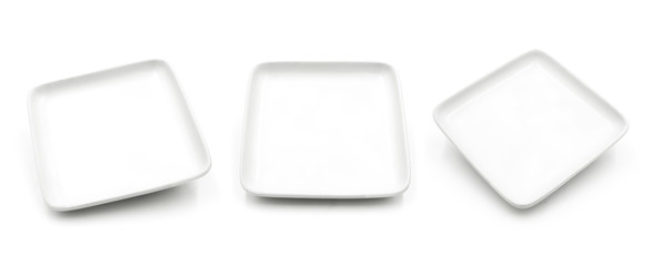 Set of white square ceramic dishes isolated on white background