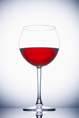 Glass of red wine on white