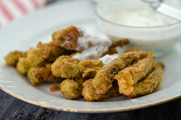 The crispy fried okra in container and spicy yogurt sauce