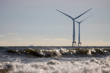 Off shore coastal wind farm near Aberdeen during a calm sunny October/autumn day with waves/people...