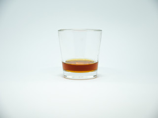 glass of whiskey with ice isolated on white background