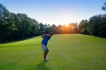Golfer playing golf in beautiful golf course in the evening golf course