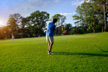 Golfer playing golf in beautiful golf course in the evening golf course