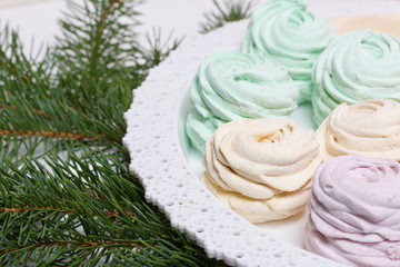 Desserts for winter parties. Sweets and spruce branch.