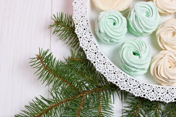 Desserts for winter parties. Sweets and spruce branch.