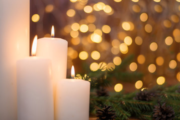Tree branches, cones, bokeh lights, candles. Preparation for the New year