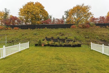 Beautiful  landscape in a autumn day. Small garden in plastic pots and pallet collars. Beautiful nature backgrounds. Gardening concept.