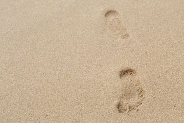 footprints on the brown sand in Thailand