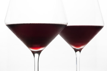 A glasses of red wine close-up on a light background. Minimalism. Copy space. The concept of tasting, wine selection.