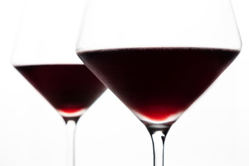 A glasses of red wine close-up on a light background. Minimalism. Copy space. The concept of tasting, wine selection.
