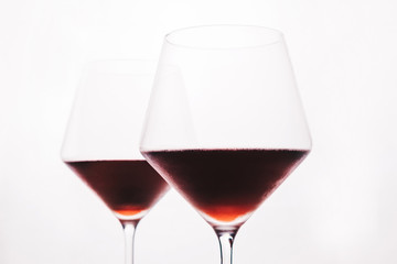 A glasses of red wine close-up on a light background. Minimalism. Copy space. The concept of tasting, wine selection. ..