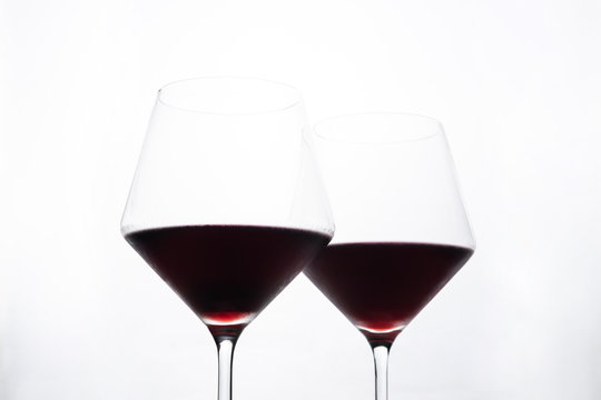 A glasses of red wine close-up on a light background. Minimalism. Copy space. The concept of tasting, wine selection.
