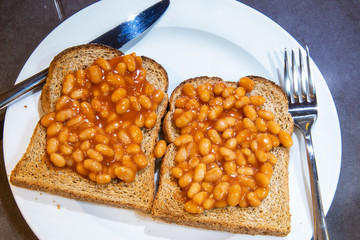 Baked beans on toast. Baked beans on two slices of brown whole meal toast. Toast topped with...