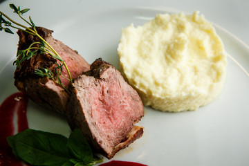 macro view on delicious barbecued meat pieces with mashed potato