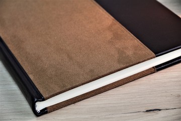 notebook on wooden table with coffee and pen