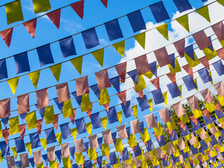 Fototapeta premium National holiday. Colourful flags and the sky