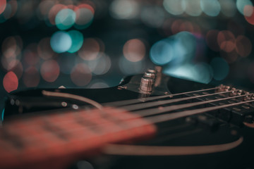 Electric bass guitar blurred background with beautiful bokeh.