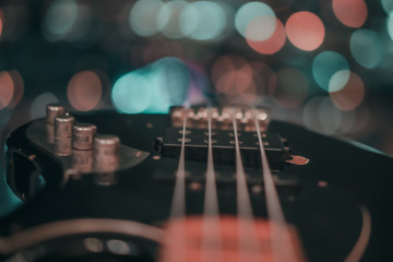 Electric bass guitar blurred background with beautiful bokeh.